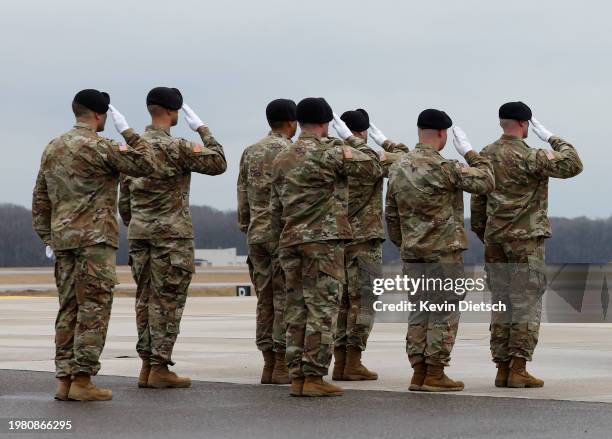 Army transfer team salutes as the flag draped transfer cases containing the remains of fallen service members U.S. Army Sgt. William Rivers, Sgt....