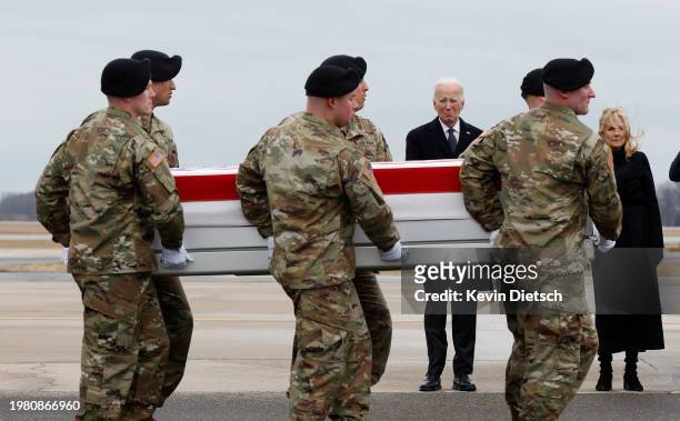 President Joe Biden and first lady Jill Biden pay their respects as a U.S. Army carry team moves a flagged draped transfer case containing the...