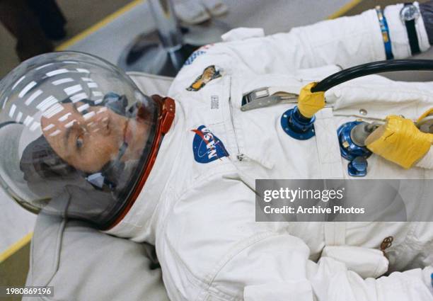 Astronaut John L. Swigert Jr., command module pilot for the Apollo 13 mission in the suiting up room at the Kennedy Space Center's Manned Spacecraft...