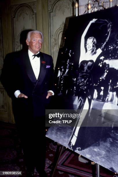 American actor Douglas Fairbanks Jr. Poses for a portrait next to a photo of actress Rita Hayworth, at the first National Alzheimer's Disease and...