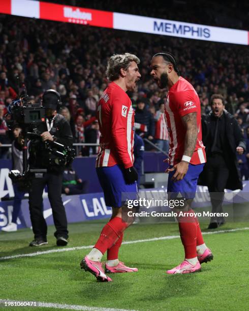 Memphis Depay of Atletico de Madrid celebrates scoring their third goal with teammate Antoine Griezmann during the LaLiga EA Sports match between...