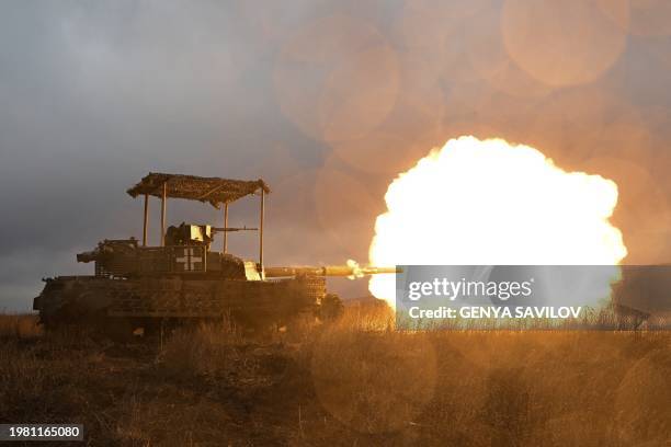 Ukrainian servicemen fire with a tank as they check it after a maintenance not far from Bakhmut in the Donetsk region on February 5 amid the Russian...