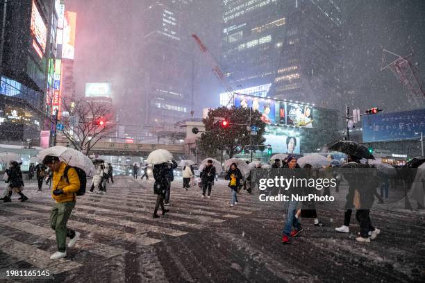 People are walking through the intersection at Shibuya in heavy snow in Tokyo, Japan, on February 5.