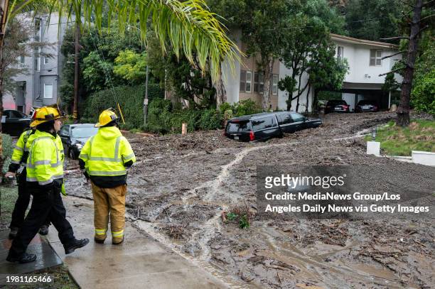 Studio City, CA Firefighters look over damage from a large mudslide which occurred at the intersection of Beverly Drive and Beverly Place in the...
