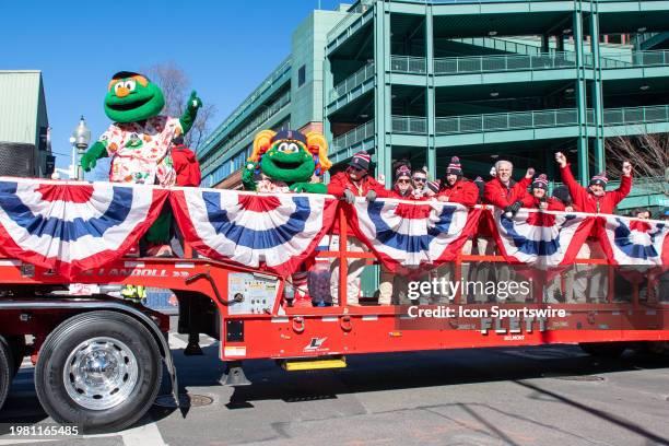 Flatbed truck with Boston Red Sox mascots Wally the Green Monster and Tessie the Green Monster and Fenway Ambassadors departs Fenway Park ahead of...