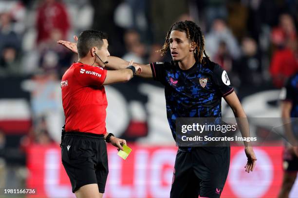 Hannibal Mejbri of Sevilla FC receives a yellow card from referee Francisco Jose Hernandez Maeso during the LaLiga EA Sports match between Rayo...