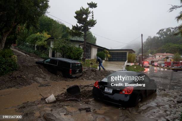 Resident moves mud and rocks from a mudslide during a storm in Los Angeles, California, US, on Monday, Feb. 5, 2024. Los Angeles and the wealthy...