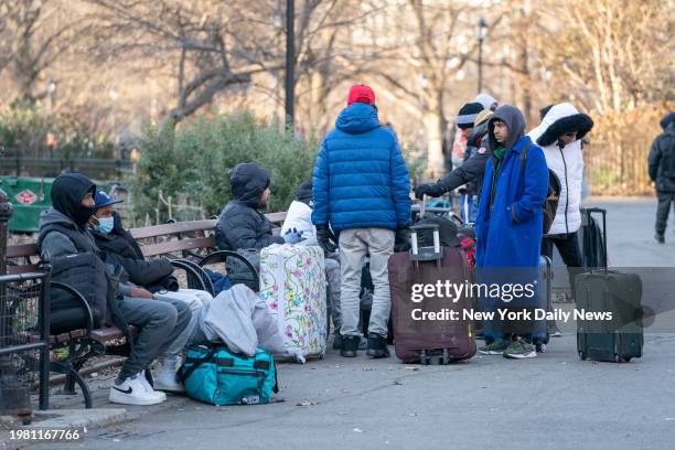 Migrants sit in Tompkins Square Park across from a migrant re-ticketing center at St. Brigid School on E. 7th St. Friday, Jan. 5 in Manhattan.