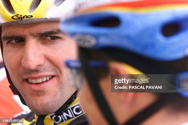 Spanish Abraham Olano, the third placed in the overall standings, chats before the 2nd stage of the 86th Tour de France in Challans, western France,...