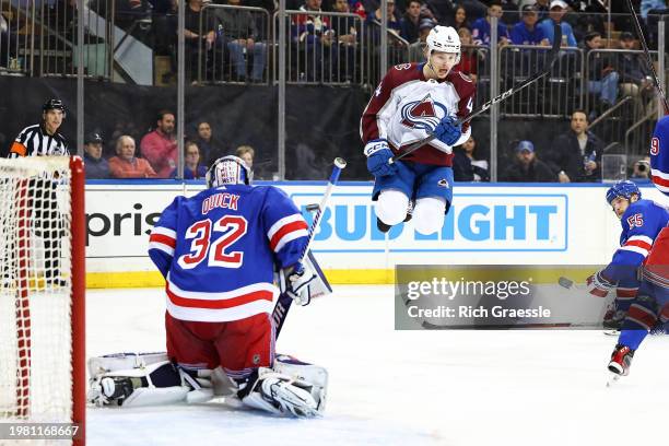 Bowen Byram of the Colorado Avalanche jumps up in front of Jonathan Quick of the New York Rangers on a shot during the first period of the game on on...