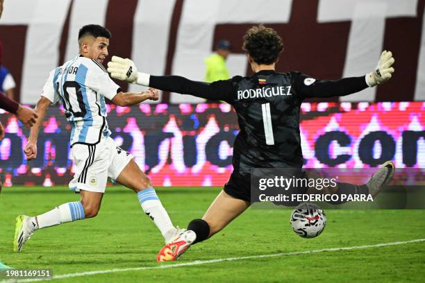 Argentina's Thiago Almada shoots to score a goal during the Venezuela 2024 CONMEBOL Pre-Olympic Tournament football match between Argentina and...