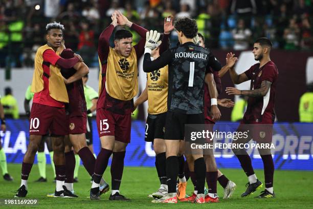 Venezuelan players celebrate after the end of the Venezuela 2024 CONMEBOL Pre-Olympic Tournament football match between Argentina and Venezuela at...