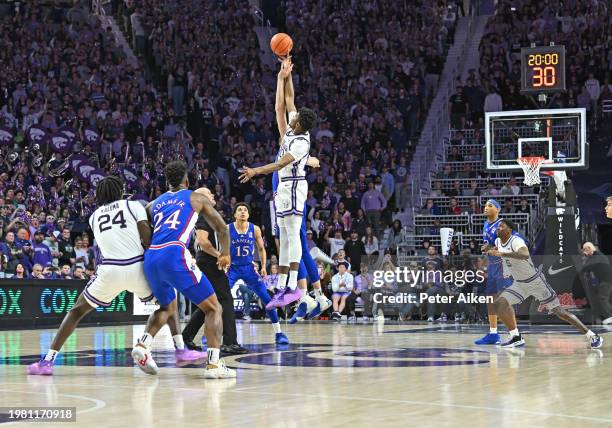 Jerrell Colbert of Kansas State Wildcats goes up for the opening tip-off against Hunter Dickinson of Kansas Jayhawks at Bramlage Coliseum on February...