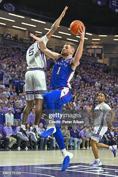 Hunter Dickinson of the Kansas Jayhawks goes to the basket against Chris Carter of the Kansas State Wildcats in the first half at Bramlage Coliseum...