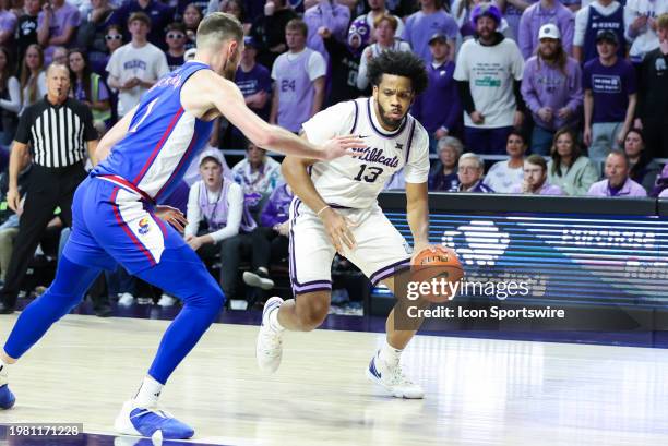 Kansas State Wildcats forward Will McNair Jr. Looks to dribble past Kansas Jayhawks center Hunter Dickinson in the first half of a Big 12 basketball...