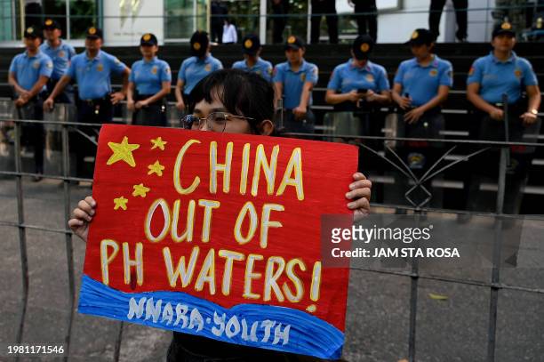 Protester raises a placard during a demonstration to condemn China's aggression in the disputed South China Sea, in front of the Chinese Consulate in...