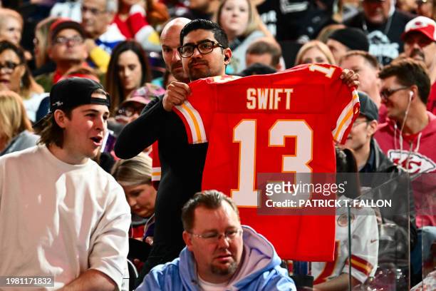Fan holds up a Kansas City Chiefs jersey with Swift during Super Bowl LVIII Opening Night at Allegiant Stadium in Las Vegas, Nevada on February 5,...
