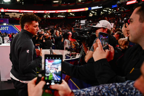 Quarterback Patrick Mahomes of the Kansas City Chiefs speaks with comedian Guillermo Rodriguez during Super Bowl LVIII Opening Night at Allegiant...