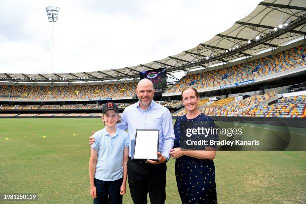 Umpire Andrew Crozier poses for a photo with his family during the Sheffield Shield match between Queensland and Tasmania at The Gabba, on February...