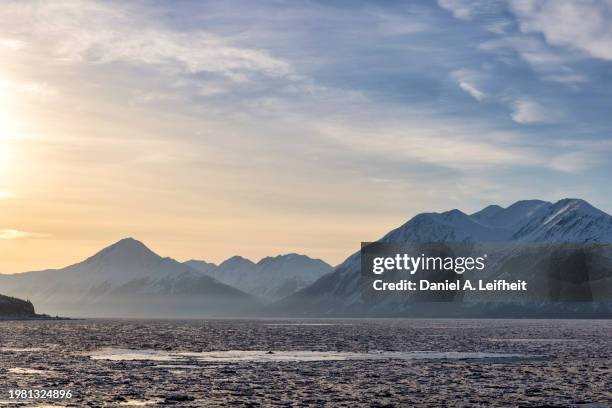 dawn in the mountains of alaska - dramatic sky mountain stock pictures, royalty-free photos & images