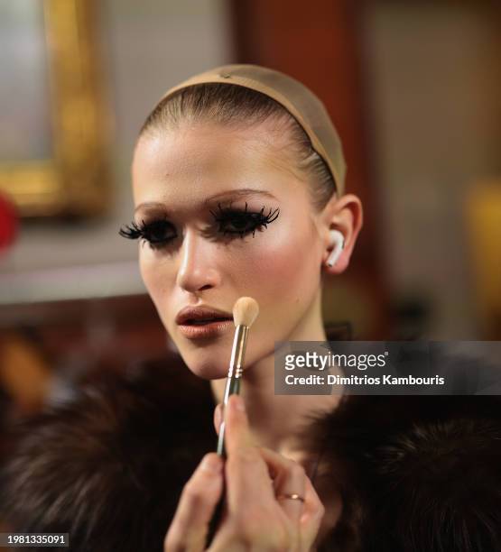 Model prepares backstage at the Marc Jacobs Runway 2024 Show at the Park Avenue Armory on February 02, 2024 in New York City.