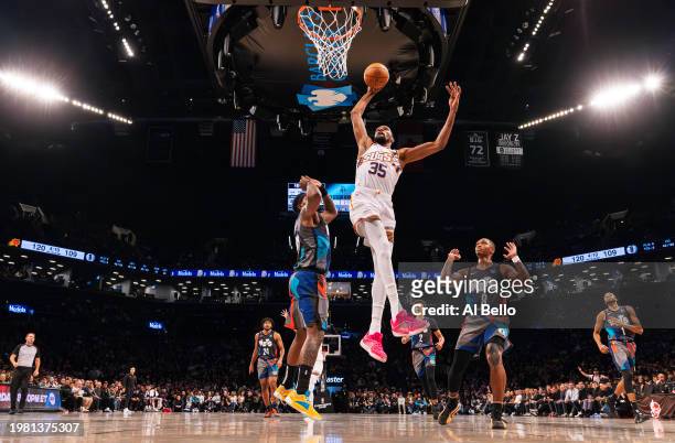 Kevin Durant of the Phoenix Suns dunks against Royce O'Neale of the Brooklyn Nets and 1 of the Brooklyn Nets during their game at Barclays Center on...