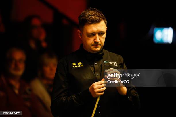 Kyren Wilson of England chalks the cue in the quarter-final match against Fan Zhengyi of China on day 5 of 2024 BetVictor German Masters at Tempodrom...