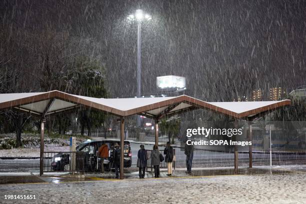 Passengers wait for a taxi near a subway station in Yokohama during a rare snow day in Kanto area . The greater Tokyo area also known as Kant-area...