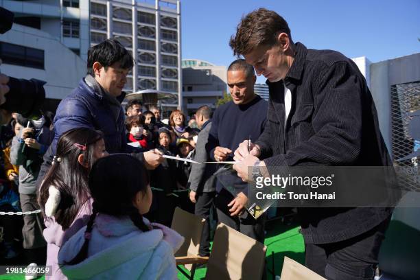 Aaron Smith and Beauden Barrett of Toyota Verblitz interact with young fans prior to the preseason match between Tokyo Suntory Sungoliath and Blues...