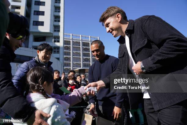 Aaron Smith and Beauden Barrett of Toyota Verblitz interact with young fans prior to the preseason match between Tokyo Suntory Sungoliath and Blues...