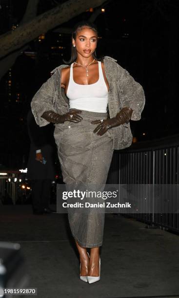 Lori Harvey is seen wearing a Marc Jacobs gray jacket and skirt, white top and white shoes with brown gloves outside the Marc Jacobs show on February...