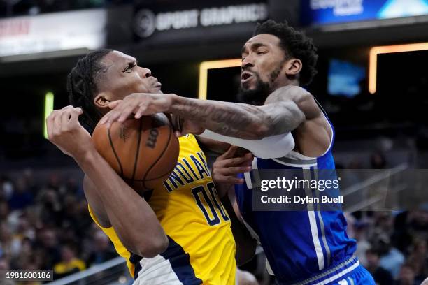 Bennedict Mathurin of the Indiana Pacers attempts a shot while being guarded by Malik Monk of the Sacramento Kings in the third quarter at Gainbridge...