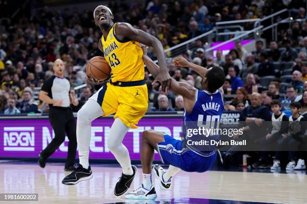 Pascal Siakam of the Indiana Pacers dribbles the ball while being guarded by Harrison Barnes of the Sacramento Kings in the third quarter at...