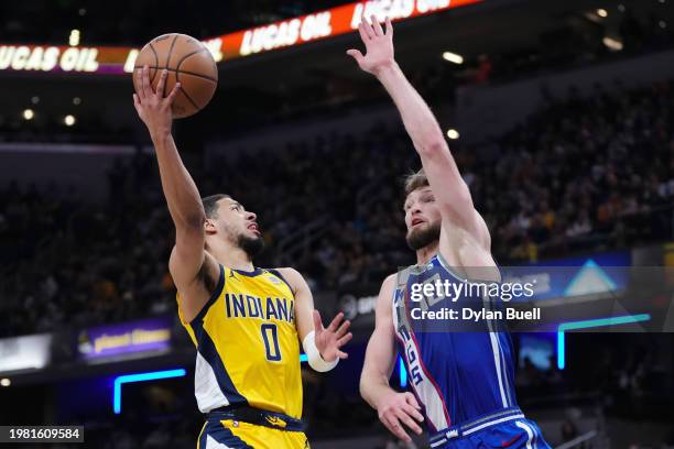 Tyrese Haliburton of the Indiana Pacers attempts a shot while being guarded by Domantas Sabonis of the Sacramento Kings in the third quarter at...