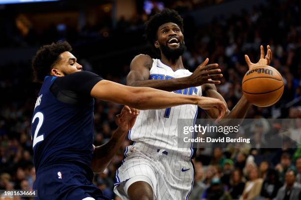 Karl-Anthony Towns of the Minnesota Timberwolves blocks a shot by Jonathan Isaac of the Orlando Magic in the fourth quarter at Target Center on...