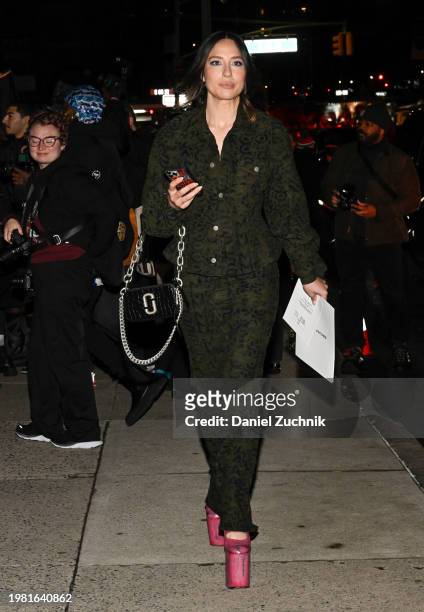Tefi Pessoa is seen wearing a green print Marc Jacobs outfit, pink boots and black and silver Marc Jacobs bag and white bow outside the Marc Jacobs...