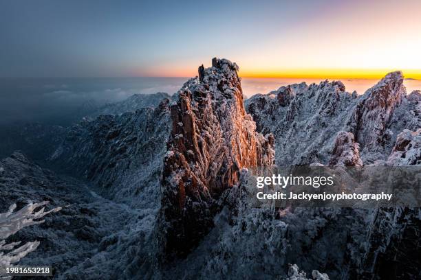 the huangshan scenic area in anhui province, china, features a picturesque sunrise over the huangshan mountains. - huangshan mountain range anhui province china stock pictures, royalty-free photos & images