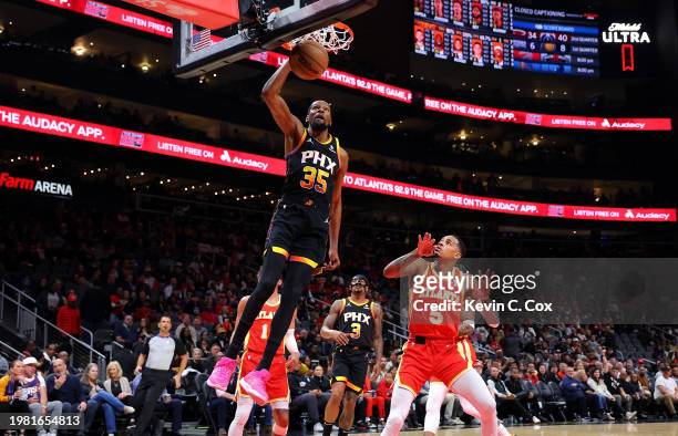 Kevin Durant of the Phoenix Suns dunks against Dejounte Murray of the Atlanta Hawks during the first quarter at State Farm Arena on February 02, 2024...