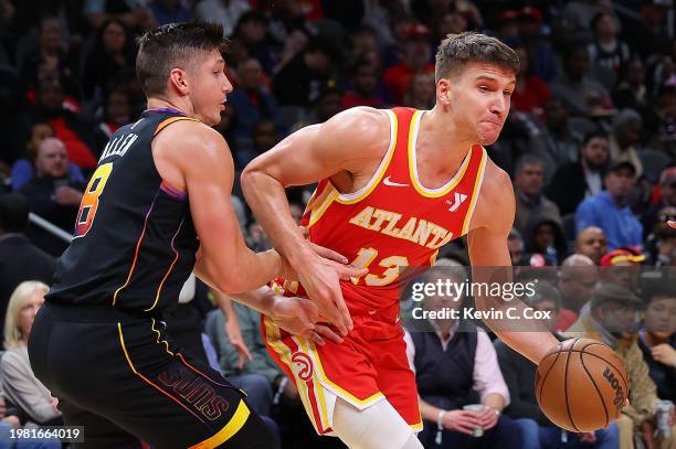 Bogdan Bogdanovic of the Atlanta Hawks drives against Grayson Allen of the Phoenix Suns during the third quarter at State Farm Arena on February 02,...