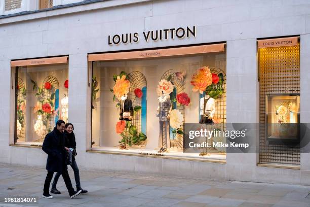 People passing the Louis Vuitton store on Bond Street which has seen a recent drop in demand for luxury goods and with some stores deciding to move...