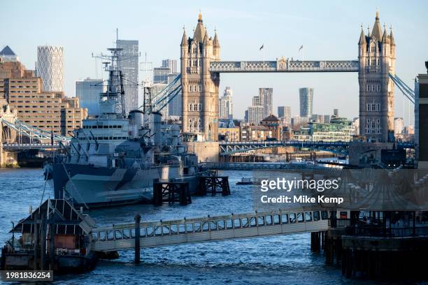 View looking along the River Thames towards HMS Belfast and Tower Bridge with the skyscrapers of Canary Wharf financial district in the distance in...