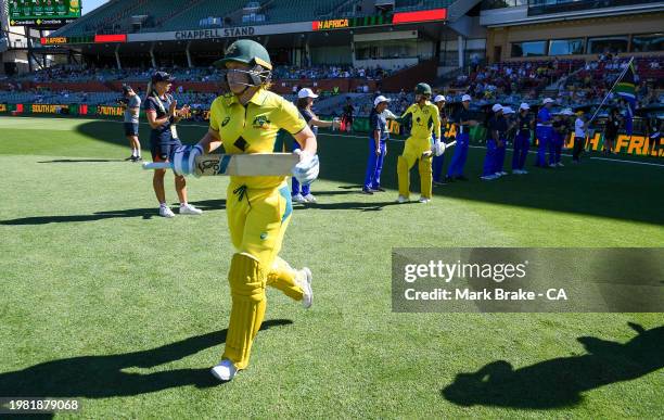 Alyssa Healy captain of Australia and Phoebe Litchfield of Australia head out to open the batting during game one of the women's One Day...