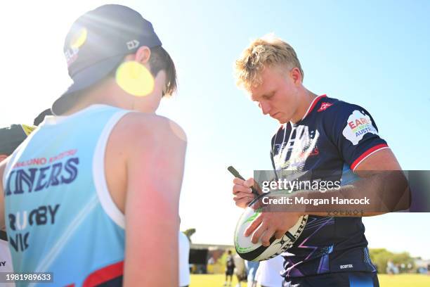 Carter Gordon of the Rebels signs a football for a fan during the Super Rugby Pacific Trial Match between Melbourne Rebels and NSW Waratahs at Harold...