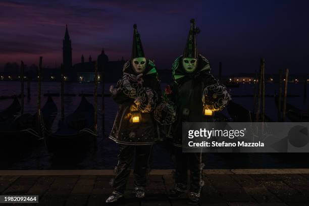Masked revelers pose for a sunrise portrait in St. Mark's Square during the Venice Carnival 2024 on February 03, 2024 in Venice, Italy. The Venice...