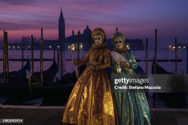 Masked revelers pose for a sunrise portrait in St. Mark's Square during the Venice Carnival 2024 on February 03, 2024 in Venice, Italy. The Venice...