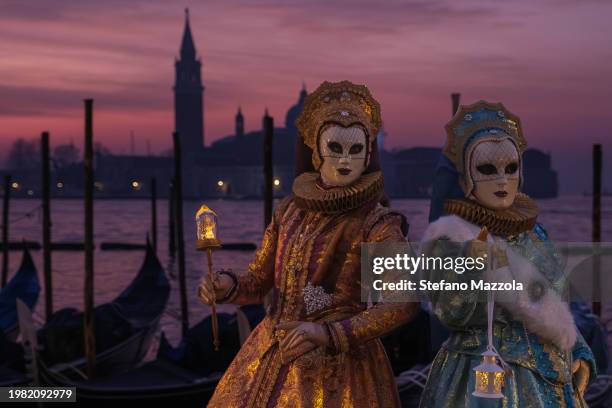 Masked revelers pose for a sunrise portrait in St. Mark's Square during the Venice Carnival 2024 on February 03, 2024 in Venice, Italy. The Venice...