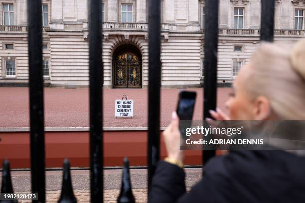 Tourists gather outside the gates of Buckingham Palace in London on February 6, 2024. King Charles III has been diagnosed with cancer and has begun...