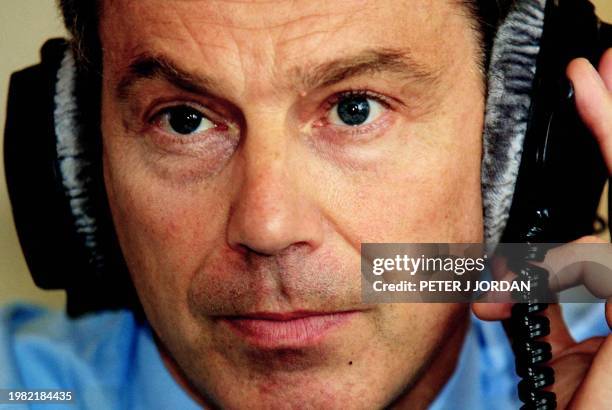 British Prime Minister Tony Blair talks on British Forces Broadcasting Services in a live radio link from Downing Street in London 26 October 2001....