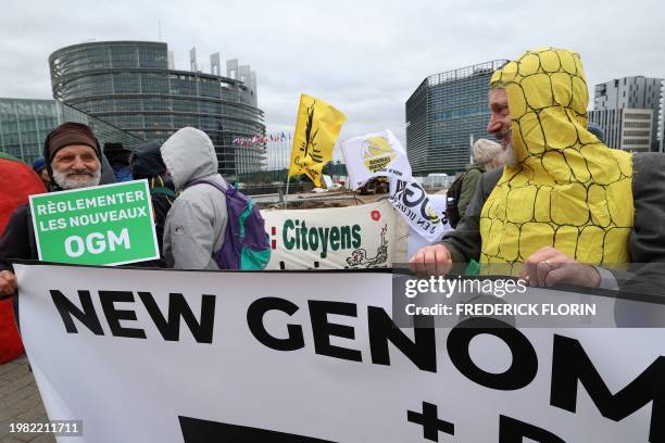 Protester holds a placard reading "regulate new GMOs" during a demonstration against new genomic techniques as part of a wave of protest accross...