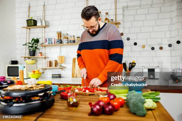 overweight man cuts vegetables for grill - fat nutrient stock pictures, royalty-free photos & images